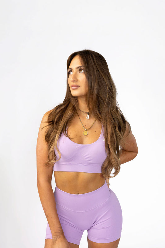 Woman wearing Mauve Sculpt Halter Sports Bra with V-neckline and medium support